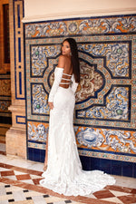Zeni Sequin Gown by Alamour The Label. Close up of the Zeni white sequin dress featuring a modern strappy open back detail & side leg slit.